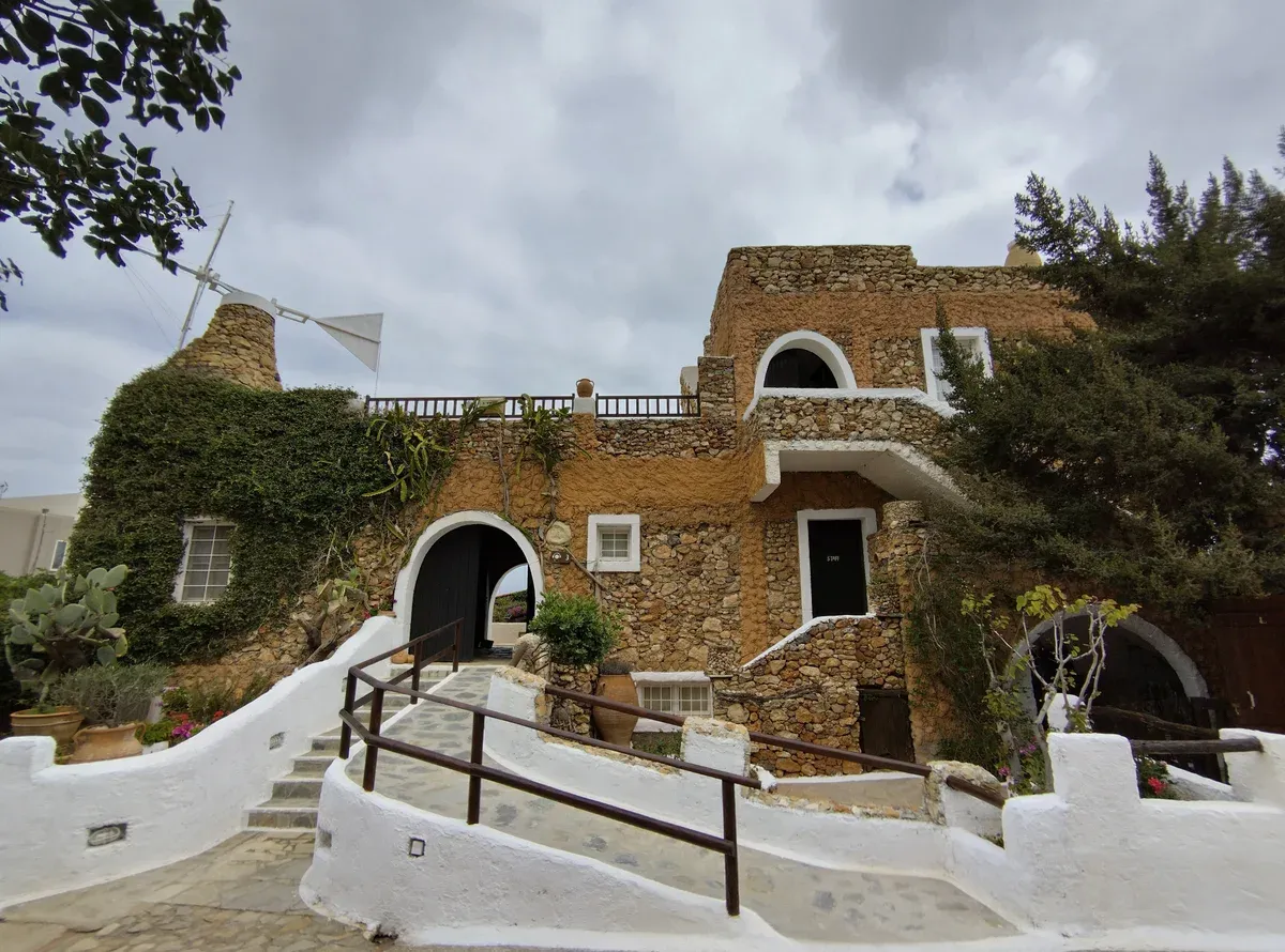 A traditional stone house and windmill at the Lychnostatis Open Air Museum near Hersonissos, Crete