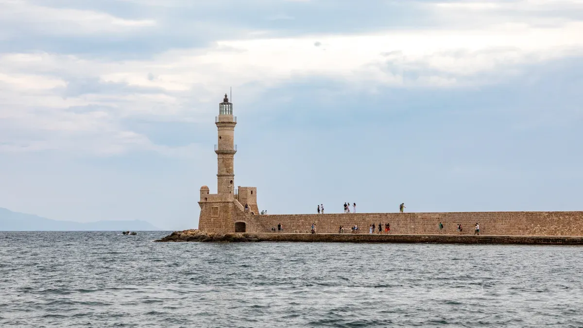 A Venetian lighthouse at the harbour entrance, part of planning a crete travel tips arrival
