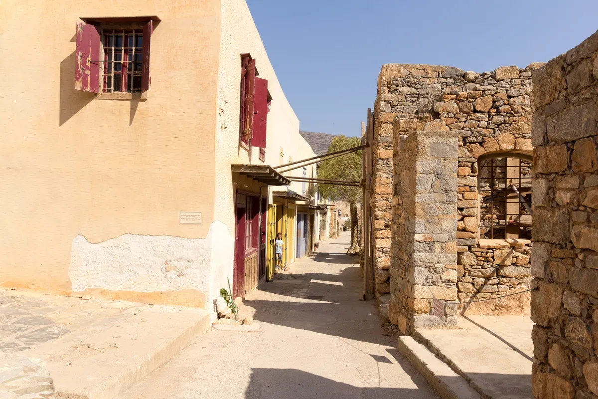 Restored colourful street inside Spinalonga's old colony, seen on a boat ticket day trip, Crete